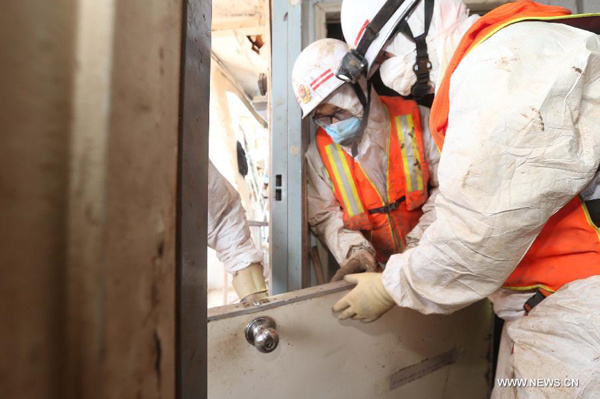 Rescuers try to dismantle the hull of Eastern Star, the passenger ship capsized by a tornado, in an effort to search for the missing in the section of Jianli on the Yangtze River, central China's Hubei Province, June 6, 2015.  (Photo/Xinhua)