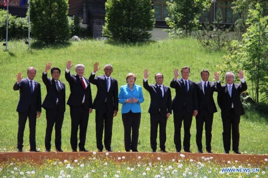Participants of the G7 summit (L-R) President of the European Council Donald Tusk, Japanese Prime Minister Shinzo Abe, Canadian Prime Minister Stephen Harper, U.S. President Barack Obama, German Chancellor Angela Merkel, French President Francois Hollande, British Prime Minister David Cameron, Italian Prime Minister Matteo Renzi and European Commission President Jean-Claude Junker have a group photo taken at the Elmau Castle near Garmisch-Partenkirchen, southern Germany, on June 7, 2015.(Xinhua/Zhu Sheng)