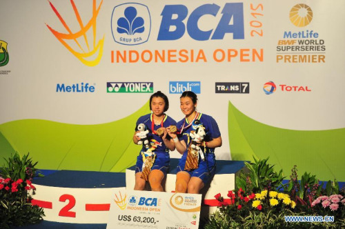 Tang Jinhua (R) and Tian Qing of China pose on the podium during the award ceremony after the women's doubles final match against Nitya Krishinda Maheswari and Greysia Polii of Indonesia on the BCA Indonesia Open 2015 in Jakarta, Indonesia, June 7, 2015. Tang Jinhua and Tian Qing won 2-0. (Xinhua/Zulkarnain)