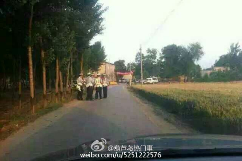 Police officers gather near a village, where four people, including two police officers, were killed in Suning county of Hebei province on Tuesday, June 9, 2015. [Photo: Weibo.com]
