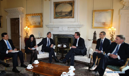 British Prime Minister David Cameron (3rd R) meets with visiting Chinese Foreign Minister Wang Yi (3rd L) in London, Great Britain, June 9, 2015. (Xinhua/Han Yan)