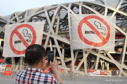 Non-smoking banners are displayed on the iconic Bird's Nest National Stadium in Beijing, capital of China, June 1, 2015. (Xinhua/Guo Haipeng)