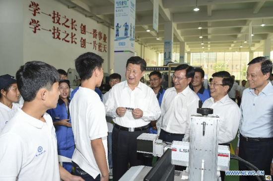 Chinese President Xi Jinping (3rd L front) visits Guizhou Machinery Industry School, a vocational college, in Guiyang, capital of southwest China's Guizhou Province, June 17, 2015. Xi had an inspection tour in Guizhou Province from June 16 to 18. (Xinhua/Li Xueren)