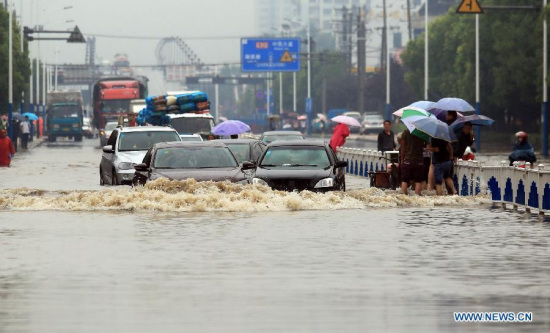 Motorcars try to pass a flooded road in Changzhou, east China's Jiangsu Province, June 17, 2015. Heavy rain on June 16 and 17 battered Jiangsu, southwest China's Chongqing Municipality, central China's Hubei Province, east China's Anhui Province and Shanghai Municipality. (Photo: Xinhua/Chen Wei)