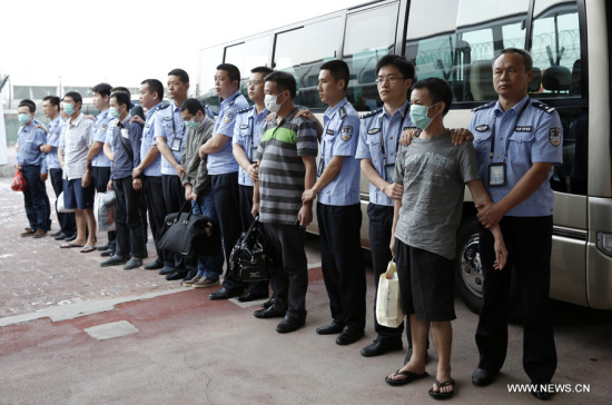 Six fugitives involvoed in economic crimes are taken back under escort from Indonesia at Capital International Airport in Beijing, capital of China, June 21, 2015.  (Photo: Xinhua/Li Mingfang)