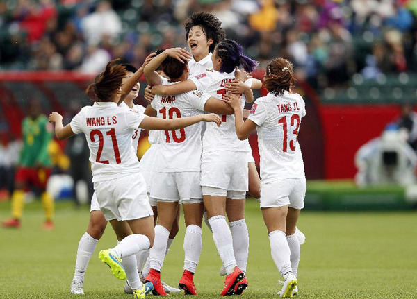 China's players celebrate a goal during a round of 16 match between China and Cameroon at the Commonwealth Stadium in Edmonton, Canada, on June 20, 2015. [Photo/Xinhua]
