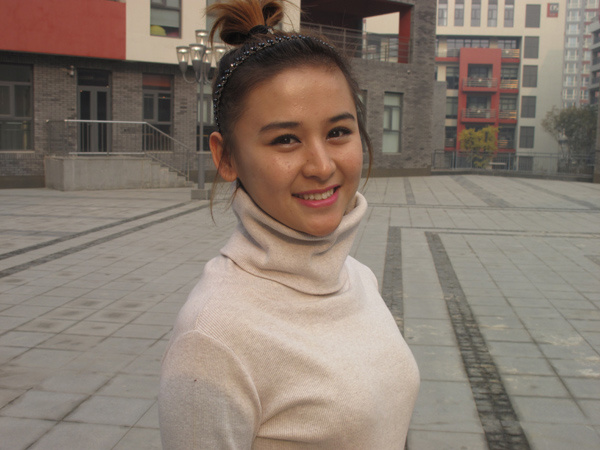 Yihebale Ilham, 24, works for a cultural company in Beijing. [Photo/China Daily]