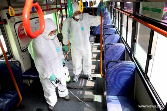 Health workers disinfect a bus in Seoul, South Korea, on June 15, 2015. (Photo/Xinhua)