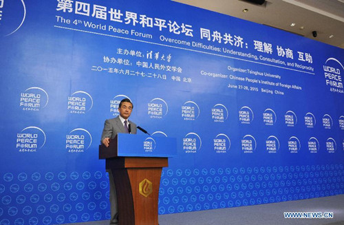 Chinese Foreign Minister Wang Yi speaks at the luncheon of the fourth World Peace Forum in Beijing, capital of China, June 27, 2015. (Xinhua/Ding Haitao) 