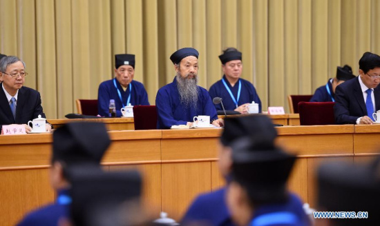 Li Guangfu (C), newly-elected chairman of China Taoist Association (CTA), addresses the closing ceremony of CTA's four-day national congress in Beijing, capital of China, June 29, 2015. Li was elected chairman of CTA according to the CTA's announcement on Monday. (Photo: Xinhua/Zhang Ling)