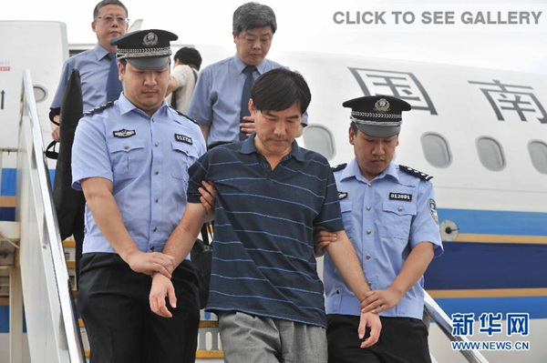 Police officers escort fugitive Sun Xin off a plane in Beijing yesterday. (Photo/Xinhua)