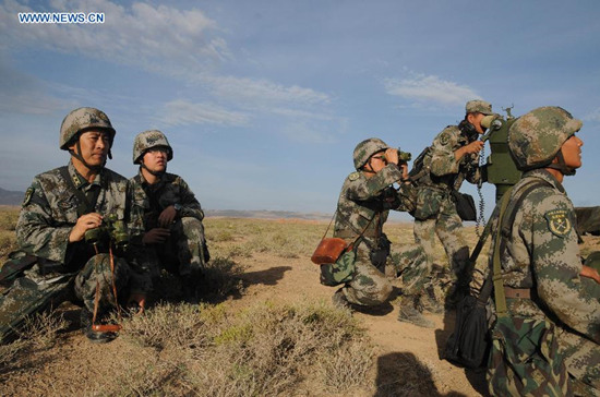 Soldiers take part in a drill in northwest China's Gansu Province, July 1, 2015. The People's Liberation Army (PLA) began a series of air-ground combat drills in Gansu on Wednesday. According to the PLA, seven live ammunition drills, dubbed Gunpower 2015 Shandan will be held in the Hexi Corridor, a green area between two large deserts, before middle September. (Photo: Xinhua/Li Yun)