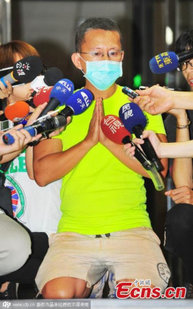 One organizer of the Color Play Asia party kneels down and apologizes after being released on bail in Taiwans New Taipei City, June 29, 2015. (Photo/CFP)