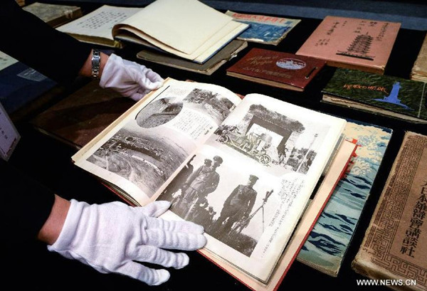 A staff member shows donated documents at the Overseas Chinese History Museum in Beijing, capital of China, July 4, 2015. Some 1,000 historical documents on Japanese aggression have been donated to the museum after China said it welcomed such evidence. (Photo: Xinhua/Li He)