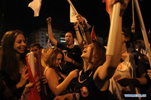 Supporters of the No vote react after the first result of the referendum at Syntagma square in Athens, Sunday, July 5, 2015. (Photo: Xinhua/Marios Lolos)