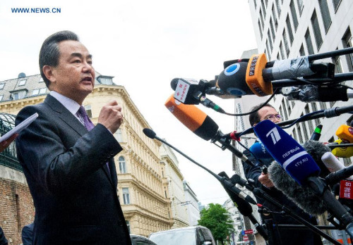 Chinese Foreign Minister Wang Yi speaks to journalists in front of the Palais Coburg hotel, the venue for nuclear talks in Vienna, Austria, July 13, 2015. (Photo: Xinhua/Qian Yi)