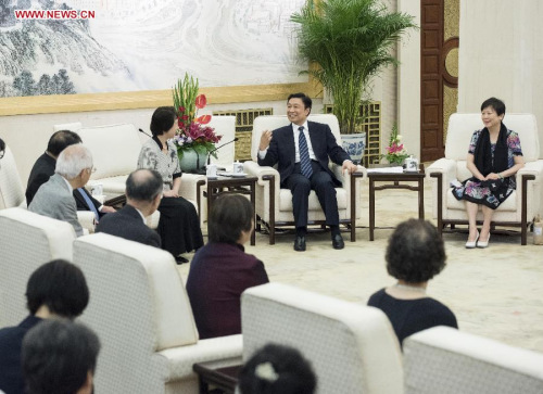Chinese Vice President Li Yuanchao (back, 2nd R) meets with a group of Japanese orphans who were raised up by Chinese families after the Chinese People's War in Resistance Against Japanese Aggression in Beijing, capital of China, July 15, 2015. (Xinhua/Wang Ye)