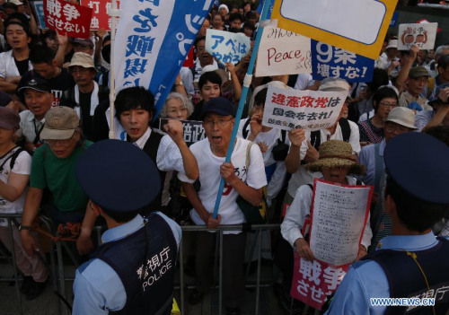 People attend a rally in front of the parliament building to protest against the controversial security bills in Tokyo, Japan, July 15, 2015. Tens of thousands people took part in the demonstration. (Photo: Xinhua/Stringer)