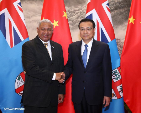 Chinese Premier Li Keqiang (R) shakes hands with Fijian Prime Minister Voreqe Bainimarama at the Great Hall of the People in Beijing, China, July 16, 2015. (Photo: Xinhua/Pang Xinglei)