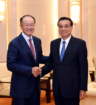 Chinese Premier Li Keqiang (R) shakes hands with World Bank President Jim Yong Kim at the Great Hall of the People in Beijing, China, July 16, 2015. (Photo: Xinhua/Rao Aimin)