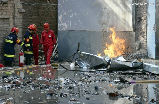 Fire fighters work at the blast site of a student dormitory at Lanzhou University in Lanzhou, capital of northwest China's Gansu Province, July 20, 2015. Seventeen people were injured after a gas blast rocked the 6-floor dorm building. (Photo: Xinhua/Deng Binshan)