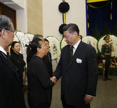 Chinese President Xi Jinping (R, front) shakes hands with a family member of Wan Li, former chairman of the National People's Congress (NPC) Standing Committee, during Wan's funeral at Babaoshan Revolutionary Cemetery in Beijing, capital of China, July 22, 2015.(Photo: Xinhua/Ju Peng)