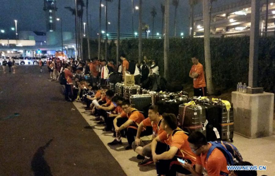 Chinese national team for 2015 Special Olympics World Summer Games wait for the shuttle bus at the Los Angeles International Airport in California, the United States, July 21, 2015. Due to the transportation failure of the Organizing Committee of 2015 Special Olympics World Summer Games, a lot of teams arriving at the airport stranded for a long time. Chinese national team got to leave the airport at 23:55 after nealy 4 hours waiting. (Photo: Xinhua/Zhao Qian)