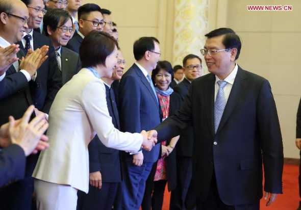 Zhang Dejiang (R), chairman of the Standing Committee of China's National People's Congress (NPC), meets with a delegation led by Starry Lee Wai-king, chairwoman of the Democratic Alliance for the Betterment and Progress of Hong Kong (DAB), at the Great Hall of the People in Beijing, July 24, 2015. (Photo: Xinhua/Ju Peng)