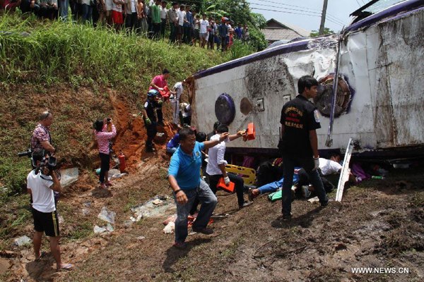 Rescuers work at the accident site in Phuket city, Thailand, on July 26, 2015. A total of 17 Chinese tourists were injured after their tour bus overturned in south Thailand's Phuket province on Sunday, China's consular office in Phuket said. (Photo/Xinhua)