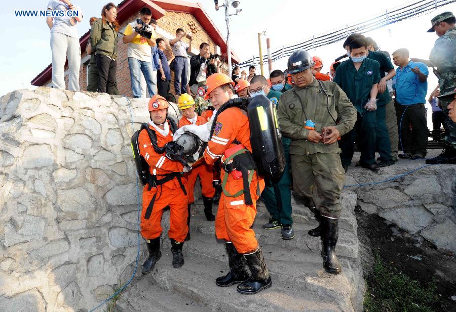 Rescuers carry a miner out of the Xuxiang Colliery in Hegang, northeast China's Heilongjiang Province, July 27, 2015. Six workers have been rescued from the flooded Xuxiang Colliery by Monday morning, when four were confirmed dead and five others were still trapped in the pit for about seven days. (Photo: Xinhua/Wang Song)