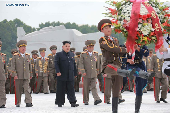 Photo provided by Korean Central News Agency (KCNA) on July 28, 2015 shows top leader of the Democratic People's Republic of Korea (DPRK) Kim Jong Un (C) visiting the Fatherland Liberation War Martyrs Cemetery on the occasion of the 62nd anniversary of the victory in the great Fatherland Liberation War of the DPRK, to pay high tribute to the fallen fighters of the People's Army on July 27, 2015. 