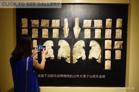 A woman visits a public exhibition of Chinese cultural relics returned by French private collectors, at Gansu Provincial Museum in Lanzhou, capital of northwest China's Gansu Province, July 20, 2015. (Photo: Xinhua/Fan Peishen) A woman visits a public exhibition of Chinese cultural relics returned by French private collectors, at Gansu Provincial Museum in Lanzhou, capital of northwest China's Gansu Province, July 20, 2015. (Photo: Xinhua/Fan Peishen)