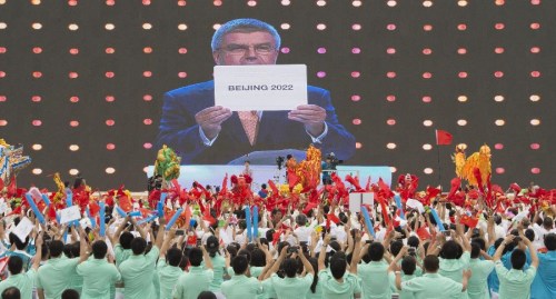 People gather to celebrate at the Olympic Green in Beijing, capital of China, July 31, 2015. Beijing, together with its neighbor city Zhangjiakou, won the bid to host the 2022 Olympic Winter Games. (Xinhua/Xie Huanchi)
