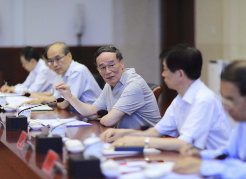 Wang Qishan (C), a member of the Standing Committee of the Political Bureau of the Communist Party of China (CPC) Central Committee and secretary of the CPC Central Commission for Discipline Inspection (CCDI), presides over a symposium for collecting suggestions on the revision of the CPC's code of ethics and punishment ordinance with directors from the leading party group of central government departments in Beijing, capital of China, July 24, 2015. (Xinhua/Lan Hongguang)