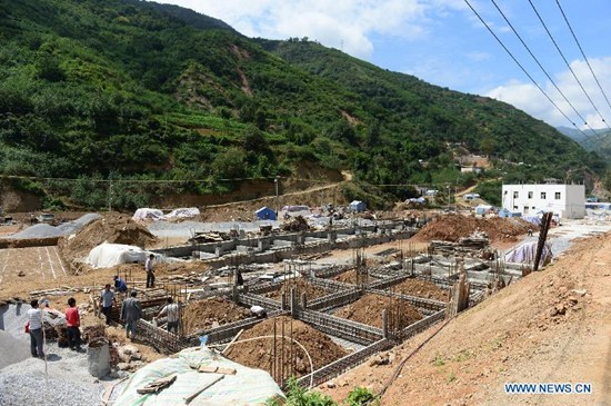 Houses are under construction in Longtoushan Town of Ludian County, southwest China's Yunnan Province, July 30, 2015. A 6.5-magnitude earthquake jolted Ludian County in Yunnan on Aug. 3, 2014. As one year has passed, the post-disaster reconstruction has been pushing forward orderly. (Photo: Xinhua/Hu Chao)