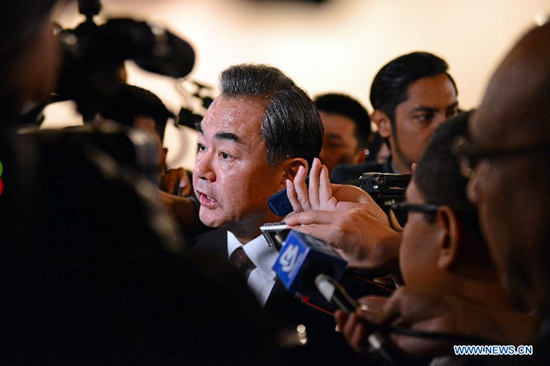 Chinese Foreign Minister Wang Yi (C) speaks to the media during the East Asia Summit Foreign Ministers' Meeting in Kuala Lumpur, Malaysia, on Aug. 6, 2015. (Xinhua/Chong Voon Chung)