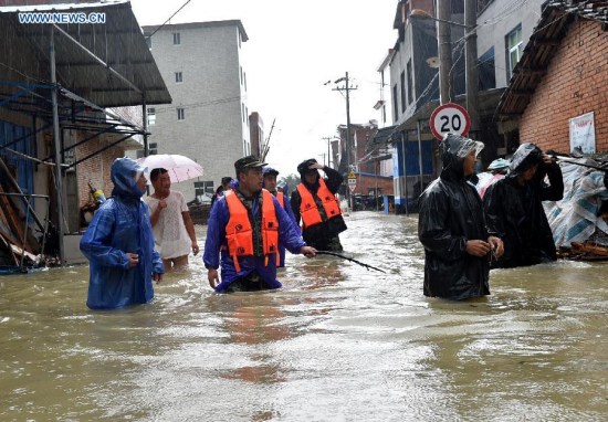 Rescuers wade through floodwater at Chengli Village of Sandu Town in Ningde City, southeast China's Fujian Province, Aug. 9, 2015. Typhoon Soudelor stormed through Fujian after it landed in the province on Saturday night. (Photo: Xinhua/Yuan Ziyou)