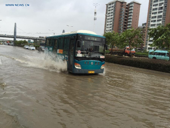 A bus runs on a waterlogged road in downtown Fuzhou, capital of southeast China's Fujian Province, Aug. 9, 2015. Typhoon Soudelor stormed through Fujian after it landed in the province on Saturday night, causing urban waterlogging in the capital city of Fuzhou. (Photo: Xinhua/Jiang Kehong)