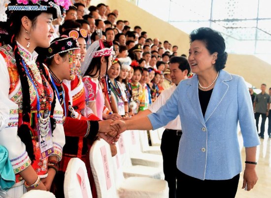 Chinese Vice Premier Liu Yandong (R front) meets with delegates from teams competing in the 10th National Traditional Games of Ethnic Minorities of China in Ordos, north China's Inner Mongolia Autonomous Region, Aug. 9, 2015. (Photo: Xinhua/Ren Junchuan)