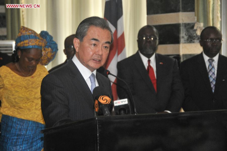 Visiting Chinese Foreign Minister Wang Yi (front) attends a press conference in Monrovia, capital of Liberia, Aug. 9, 2015. (Xinhua/Zhang Baoping)