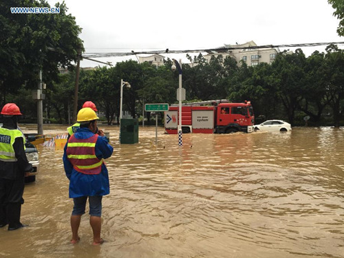 Vehicles run on a waterlogged road in downtown Fuzhou, southeast China's Fujian Province, Aug. 9, 2015. Typhoon Soudelor stormed through Fujian after it landed in the province on Saturday night, causing urban waterlogging in the capital city of Fuzhou. (Photo: Xinhua/Jiang Kehong)