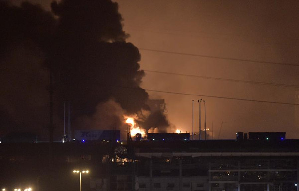 Smoke and fire are seen after an explosion in the Binhai New Area in north China's Tianjin Municipality on Aug. 13, 2015. An explosion rocked the Binhai New Area in north China's Tianjin Municipality at around 11:30 p.m. Wednesday. The cause and casualties are not immediately known. (Xinhua/Yue Yuewei)