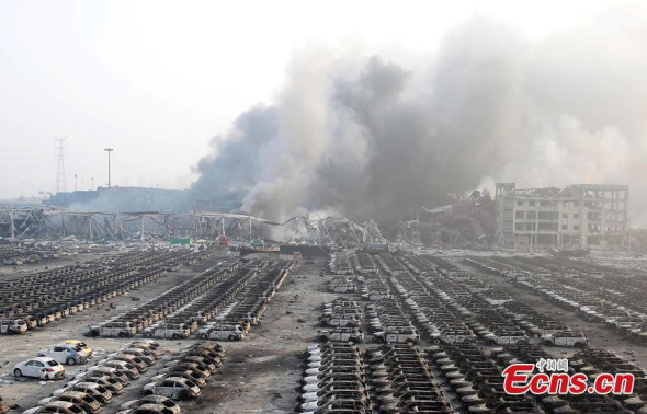 News cars are burnt down to their metal frames at a parking lot near the blast site in Tianjin municipality on August 13, 2015.   (Photo: China News Service/ Han Haidan)