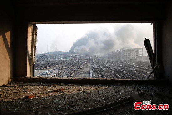 News cars are burnt down to their metal frames at a parking lot near the blast site in Tianjin municipality on August 13, 2015. Two massive explosions caused by flammable goods rocked an industrial area in the northeast Chinese port city late on Wednesday, killing at least 17 people and injuring more than 400. (Photo: China News Service/ Han Haidan)