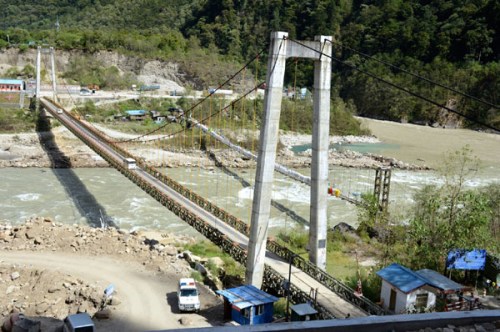 Old bridges stretching across the Parlung Tsangpo will be replaced by the Thangme Bridge by the end of this year. The oldest, right, was out of service in 2000 due to mudslides, and the current bridge, left, allows only one-way traffic. (Photo by Chen Bei)