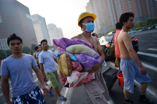 Workers at a construction site in the blast zone evacuate because of safety concerns.(Photo/Xinhua)