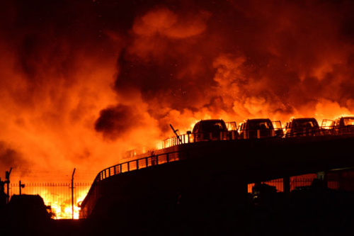 Smoke and fire are seen after an explosion in the Binhai New Area in North China's Tianjin municipality on Aug 13, 2015. (Photo/Xinhua)