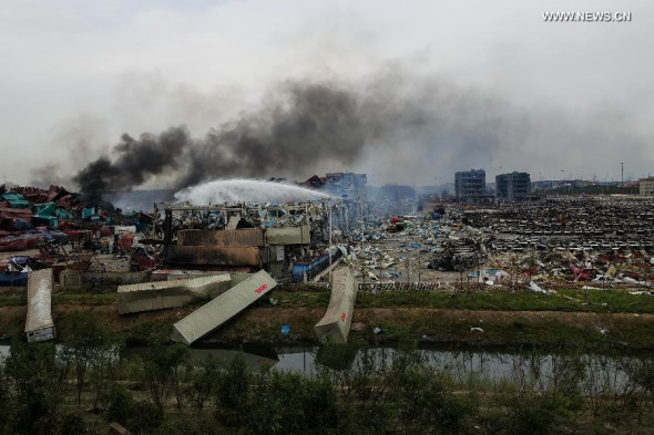 Firefighters work at the warehouse explosion site in Tianjin, north China, Aug. 14, 2015. (Photo: Xinhua/Yue Yuewei) 