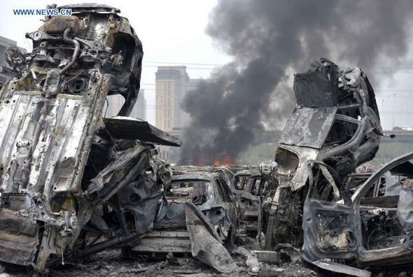Damaged cars explose and trigger new blasts at the site of explosion in Tianjin, north China, Aug. 15, 2015. Death toll rose to 85 as of Friday night, including 21 firemen, from the massive warehouse explosions hitting north China's Tianjin City Wednesday night, the rescue headquarters said Saturday. (Photo: Xinhua/Yue Yuewei)