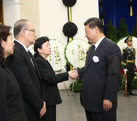 Chinese President Xi Jinping (R, front) shakes hands with a family member of Wei Jianxing, former head of China's top anti-graft body the Central Commission for Discipline Inspection of the Communist Party of China, during Wei's funeral at Babaoshan Revolutionary Cemetery in Beijing, capital of China, Aug. 16, 2015.  (Photo: Xinhua/Liu Weibing)